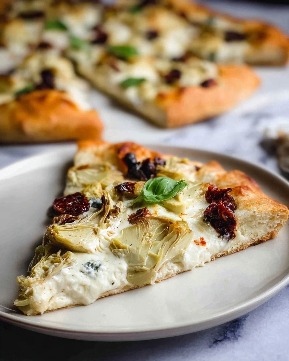 A slice of pizza with a golden brown crust forms the base layer, topped with a thick layer of melted white cheese. Scattered on top are artichoke pieces with light green and pale yellow hues, charred sun-dried tomatoes that are dark red and wrinkled, and fresh small green basil leaves adding a touch of color. The slice is set on a white plate with a smooth texture, and in the background, more slices of the same pizza rest on a white marbled surface, creating a cozy, fresh meal scene. Photo taken with an iphone --ar 4:5 --v 7