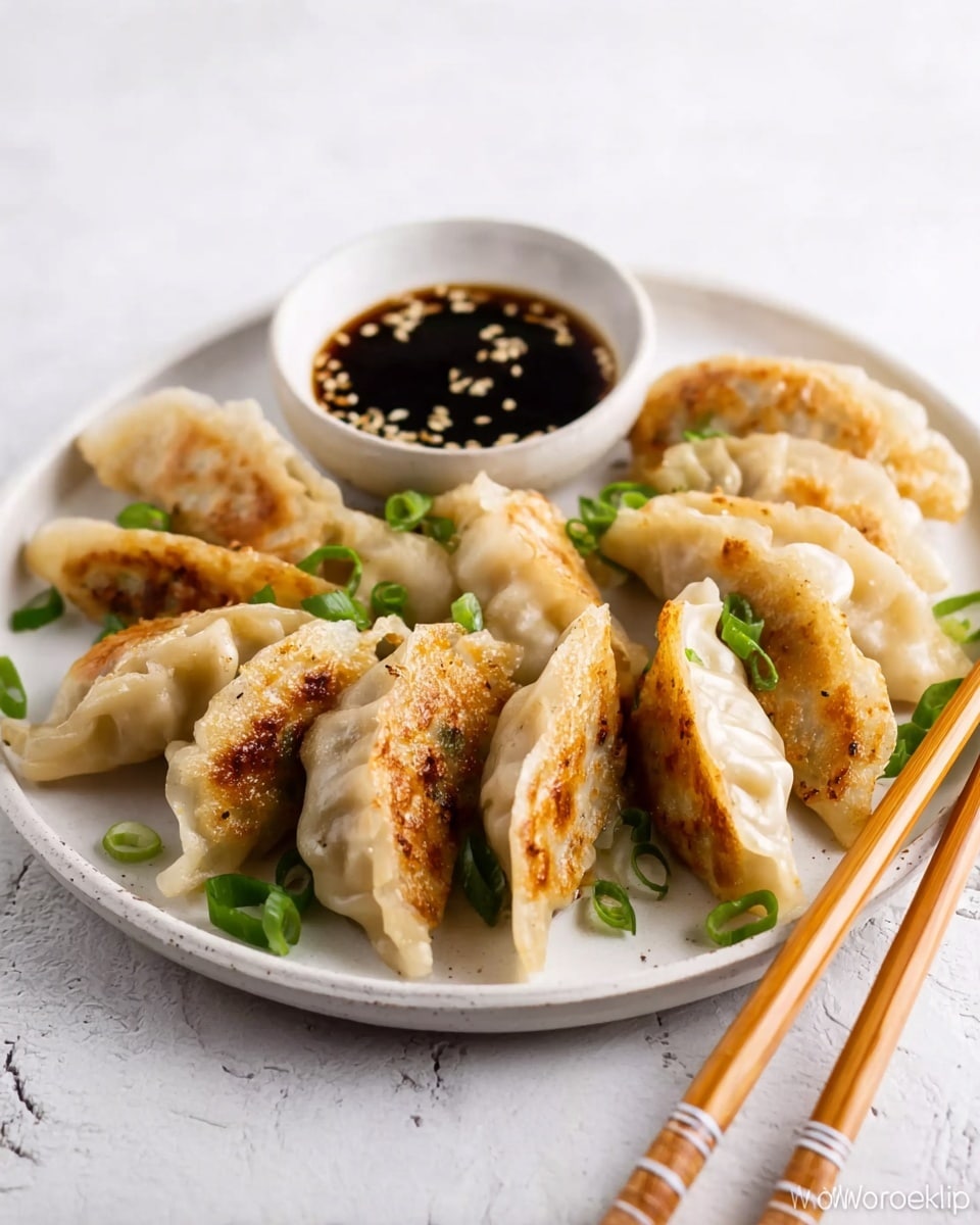 A white round plate on a white marbled surface holds a pile of ten golden-brown pan-fried dumplings with a slightly crisp texture on one side and a soft, pale dough on the other. The dumplings are arranged so they slightly overlap, with chopped green onions scattered on top and around them. Behind the dumplings, there is a small white round dish filled with dark soy dipping sauce, garnished with white sesame seeds. Resting on the edge of the plate are a pair of light brown wooden chopsticks with subtle white and dark brown striped tips. photo taken with an iphone --ar 4:5 --v 7