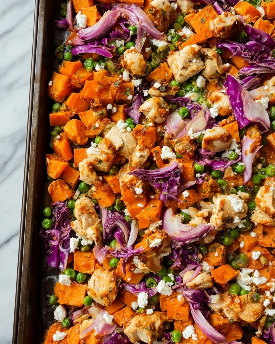 This image shows a close-up of a roasted dish filled with three main layers of ingredients. The bottom layer is made of bright orange chunks of cooked sweet potatoes, cut into small cubes. Scattered on top are pieces of crispy, golden-brown chicken, broken into irregular bite-sized chunks. Mixed throughout are small green peas and thin strips of purple cabbage, adding varied colors and textures. There are also small, white crumbs spread evenly over the dish which look like soft cheese crumbles. All ingredients lay flat on a baking tray with a dark base, set on a white marbled surface. photo taken with an iphone --ar 4:5 --v 7