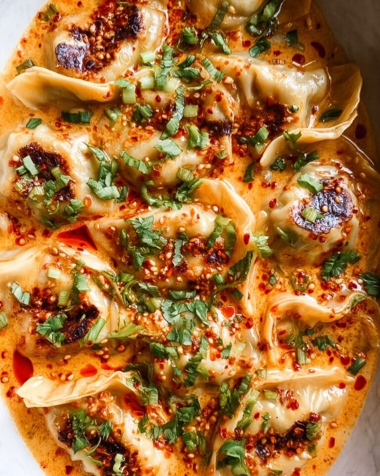 One-Pan Baked Dumplings in Coconut Curry Sauce with Fresh Herbs and Chili Crunch Recipe