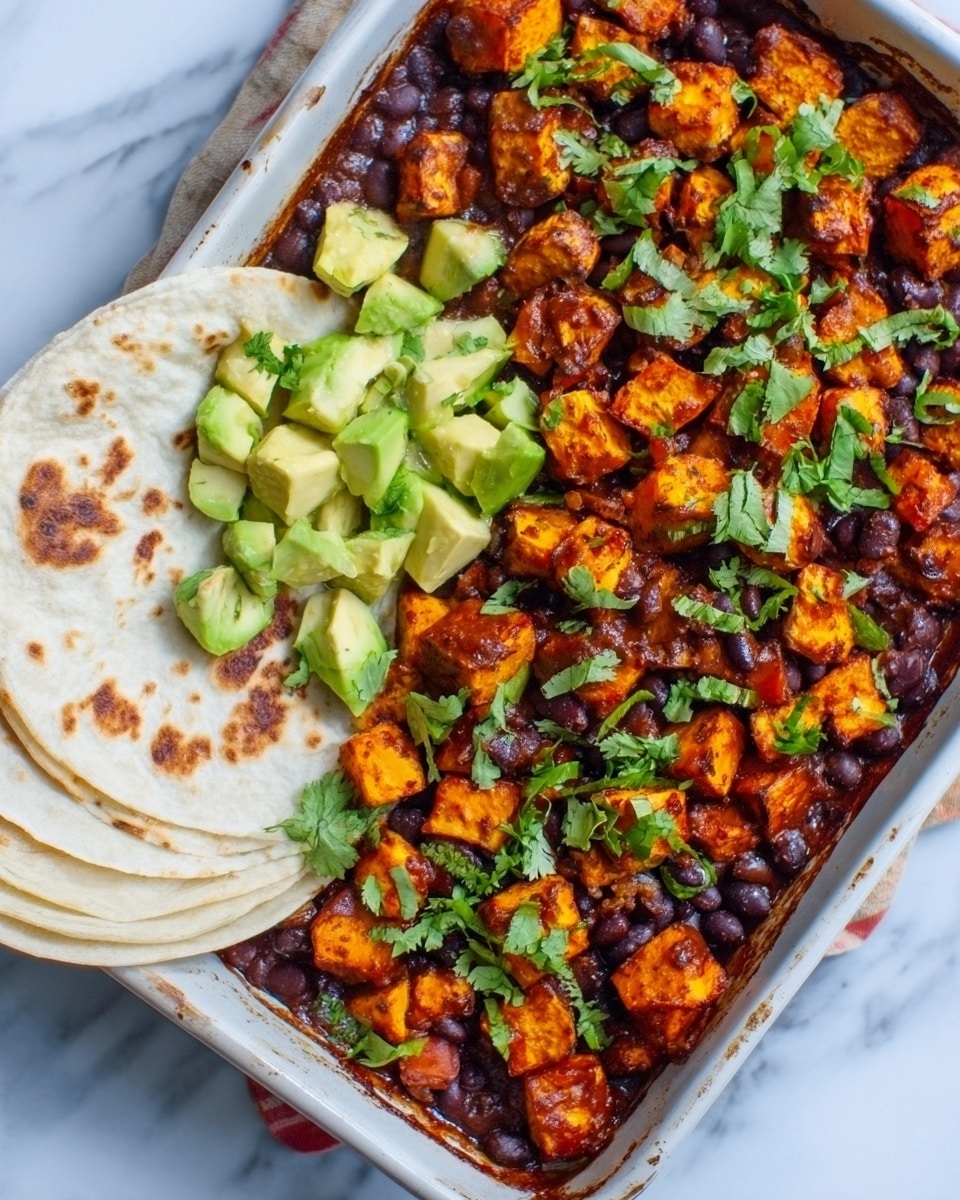 The image shows a white rectangular dish filled with a layered meal. The bottom layer is a dark red sauce with black beans scattered evenly. On top, there are small, golden-brown roasted sweet potato cubes mixed with green chopped cilantro. To the left side, there are two soft white tortillas partially folded and placed resting against the rim. Below the tortillas, chunks of pale green avocado sit in a small pile. The dish is arranged neatly on a white marbled surface. Photo taken with an iphone --ar 4:5 --v 7